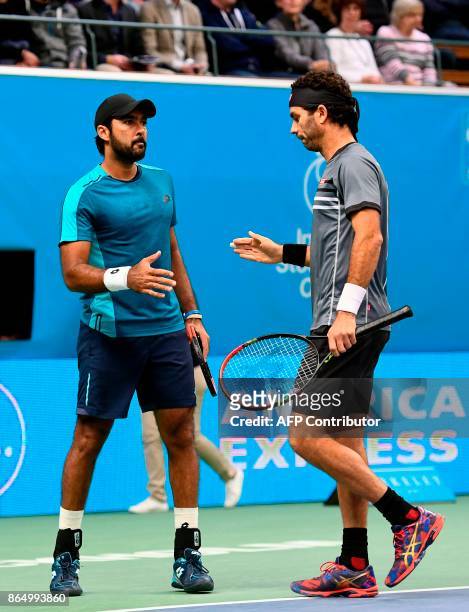 Pakistan's Aisam-Ul-Haq Qureshi and his teammate Netherland's Jean-Julien Rojer react after a point against Austria's Oliver Marach and Croatia's...