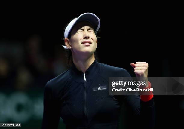 Garbine Muguruza of Spain celebrates victory in her singles match against Jelena Ostapenko of Latvia during day 1 of the BNP Paribas WTA Finals...