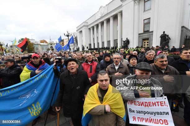 Protestors sing the Ukrainian national anthem as they take part in a demonstration of opposition's supporters in front of the Ukrainian Parliament,...