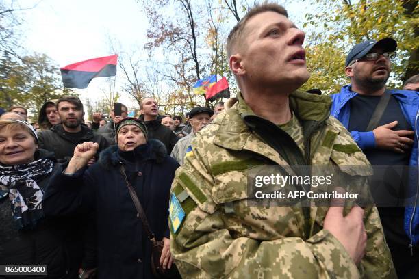Protestors sing the Ukrainian national anthem as they take part in a demonstration of opposition's supporters in front of the Ukrainian Parliament,...