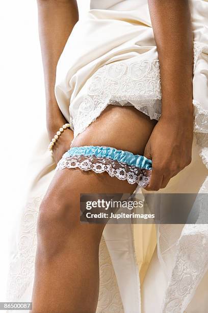Premium Photo  White girdle put on a leg of a bride shortly before the  wedding