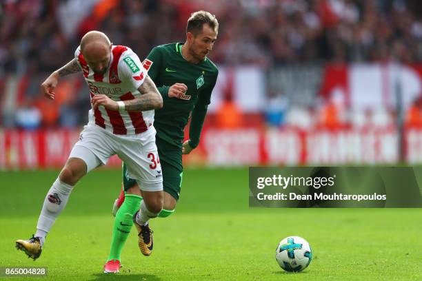 Izet Hajrovic of Werder Bremen beats Konstantin Rausch of FC Koeln during the Bundesliga match between 1. FC Koeln and SV Werder Bremen held at...