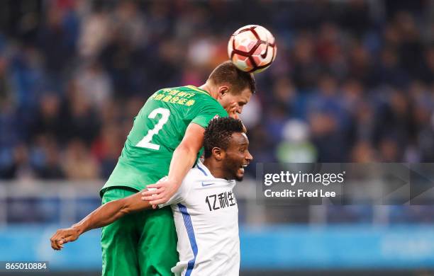 Egor Krimets of Beijing Guoan competes for an aerial ball with John Obi Mikel of Tianjin Elion FC during the Chinese Super League match between...