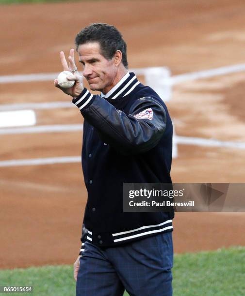 Former Yankee player Paul O'Neill waves to the crowd after throwing out the ceremonial first pitch before Game Four of the American League...