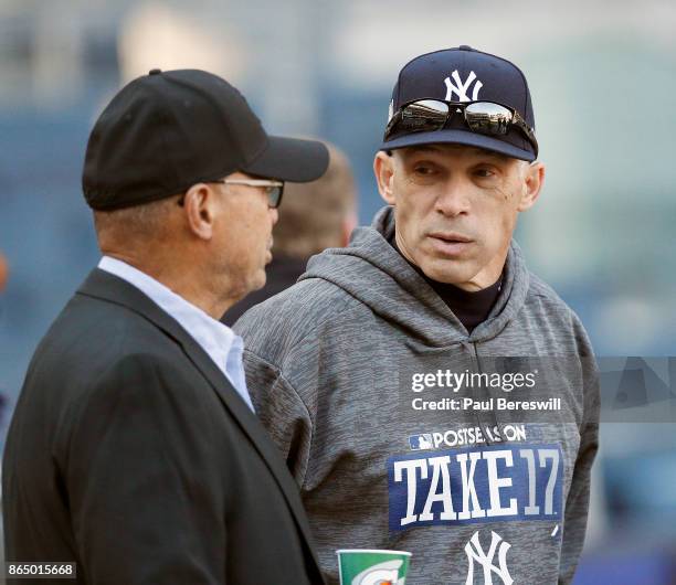 Manager Joe Girardi of the New York Yankees talks with former Yankee player Reggie Jackson during batting practice before Game Four of the American...