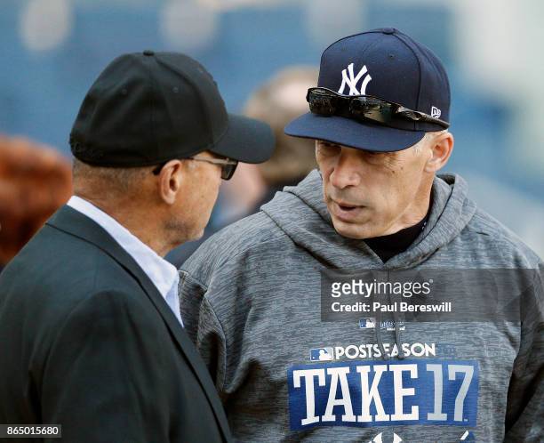 Manager Joe Girardi of the New York Yankees talks with former Yankee player Reggie Jackson during batting practice before Game Four of the American...