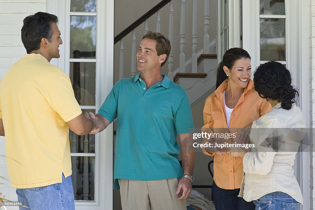 Couples greeting at house