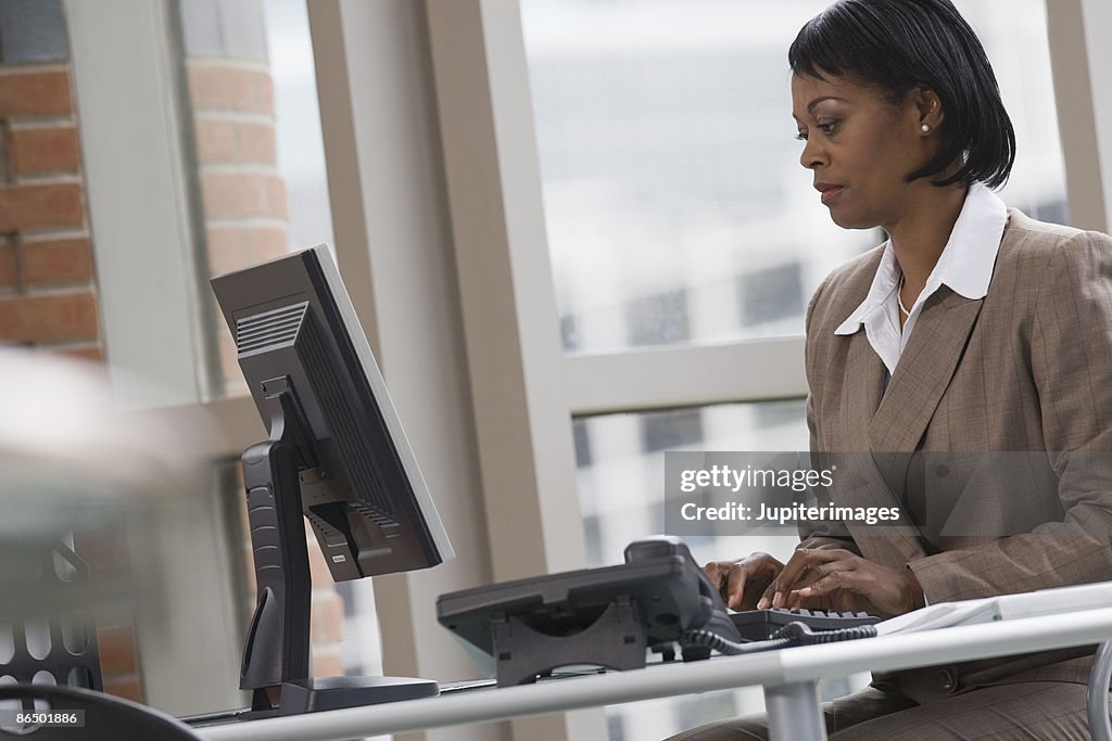 Businesswoman typing on computer
