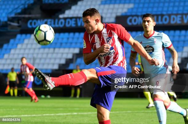 Atletico Madrid's French defender Lucas Hernandez kicks the ball next to Celta Vigo's Chilean midfielder Pablo Hernandez during the Spanish league...