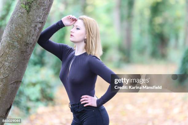 young woman in the forest during autumn/winter - lonely hearts stock pictures, royalty-free photos & images