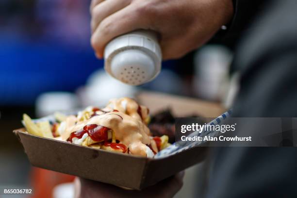 Fan enjoys food before kick off during the NFL match between the Arizona Cardinals and the Los Angeles Rams at Twickenham Stadium on October 22, 2017...