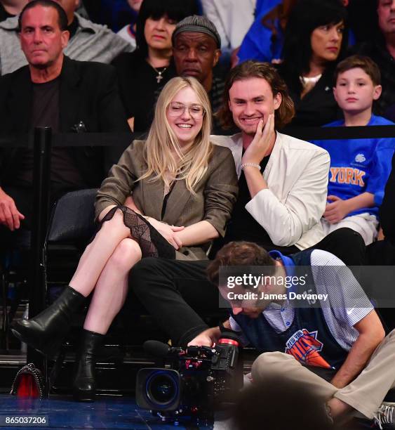 Dakota Fanning and guest attend Detroit Pistons Vs. New York Knicks game at Madison Square Garden on October 21, 2017 in New York City.