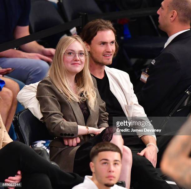 Dakota Fanning and guest attend Detroit Pistons Vs. New York Knicks game at Madison Square Garden on October 21, 2017 in New York City.