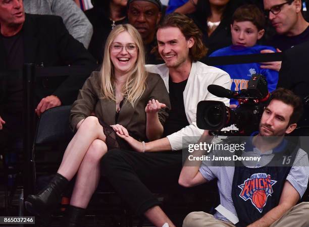 Dakota Fanning and guest attend Detroit Pistons Vs. New York Knicks game at Madison Square Garden on October 21, 2017 in New York City.