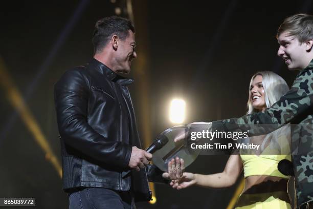 Luke Evans is presented with the award for Best Film for 'Beauty and the Beast' by Louisa Johnson and George Ezra on stage during the BBC Radio 1...