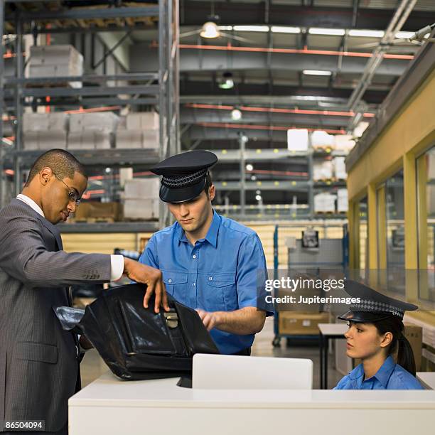 businessman and security guards at security station - racism stock pictures, royalty-free photos & images
