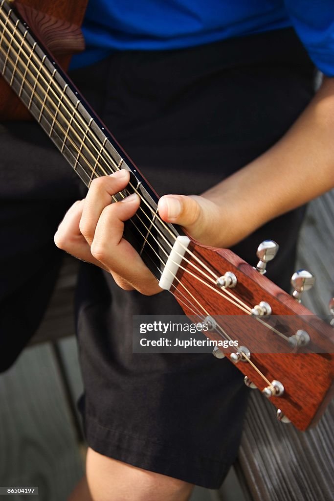 Person playing guitar