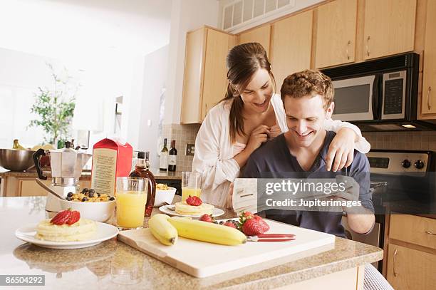 couple reading newspaper - juice box stock pictures, royalty-free photos & images