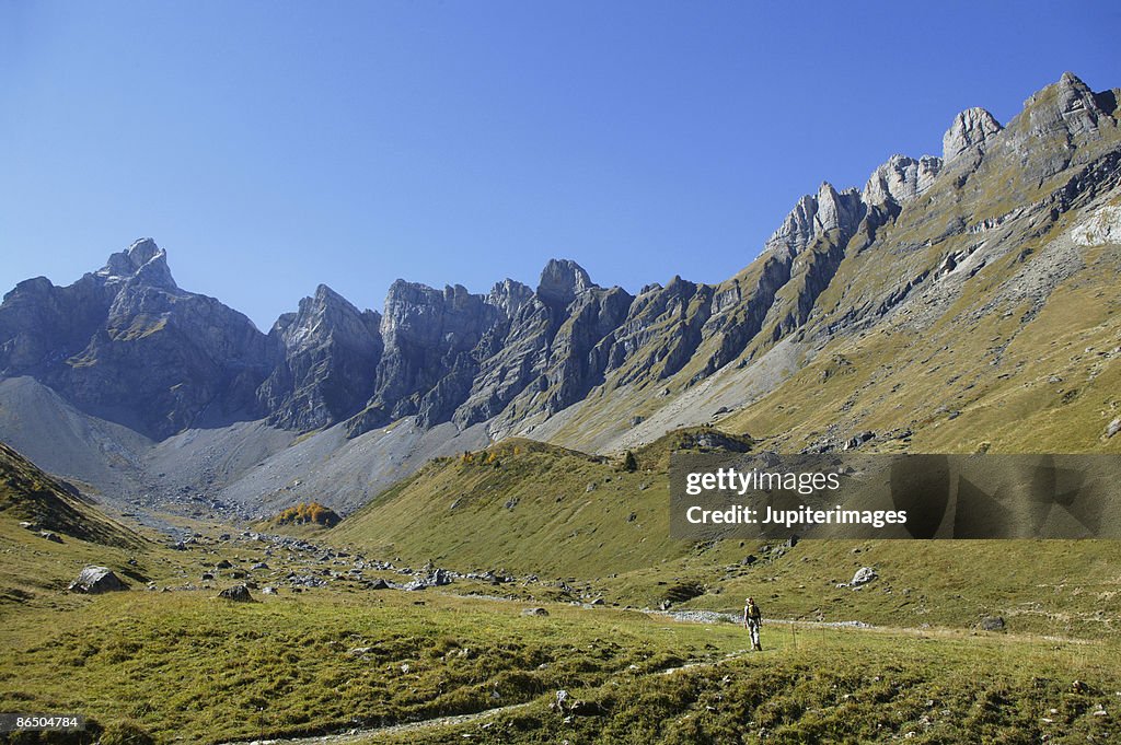 Woman hiking in mountain valley