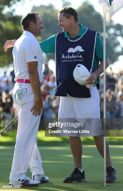 Sergio Garcia of Spain celebrates victory on the 18th green with caddie Glenn Murray during the final round of of the Andalucia Valderrama Masters at...