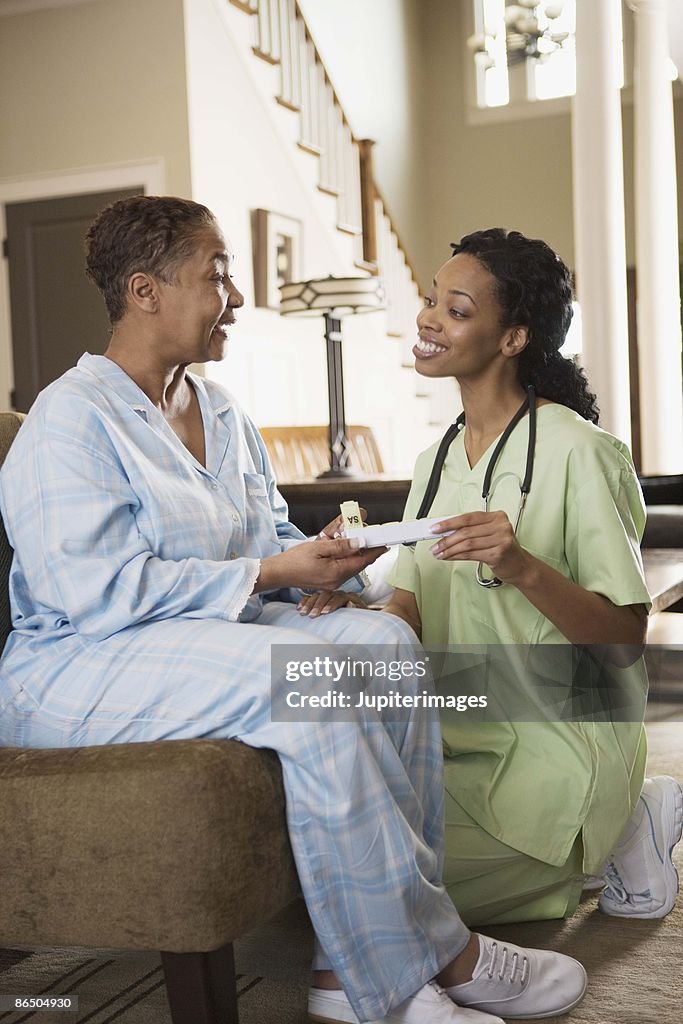 Nurse and patient at home with medication