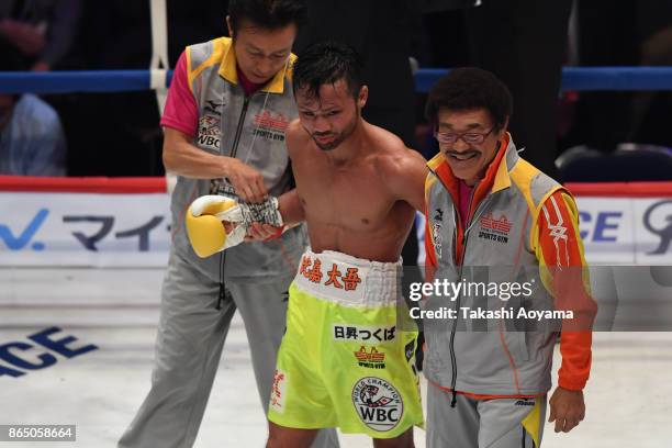 Daigo Higa and Yoko Gushiken of Japan celebrate their victory against Thomas Masson of France during their WBC Flyweight Title Bout at Ryogoku...