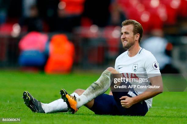 Tottenham Hotspur's English striker Harry Kane holds his leg after appearing to pick up an injury during the English Premier League football match...