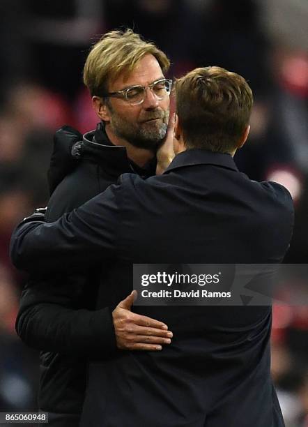 Jurgen Klopp, Manager of Liverpool and Mauricio Pochettino, Manager of Tottenham Hotspur embrace after the Premier League match between Tottenham...