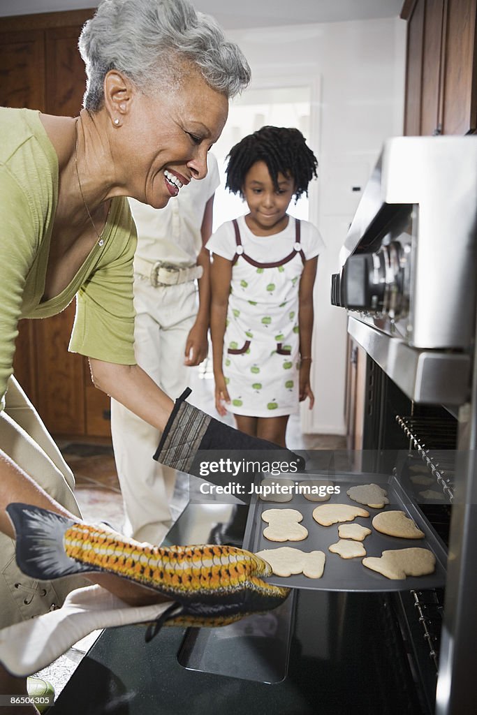 Grandmother baking cookies for grandchildren