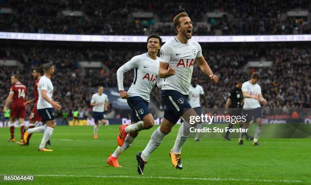 Harry Kane of Spurs celebrates with Dele Ali after scoring the fourth goal and his second of the game during the Premier League match between...