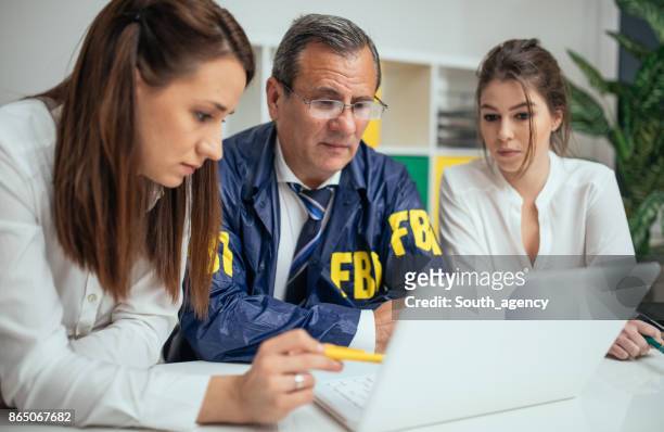 investigating a crime - female fbi stock pictures, royalty-free photos & images