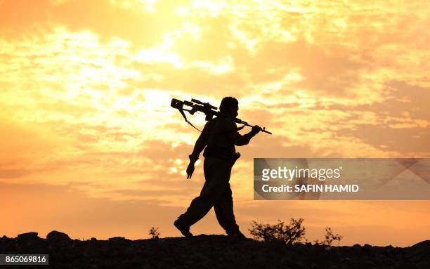 An Iranian Kurdish Peshmerga, member of the Iranian Kurdistan Democratic Party , takes part in routine military exercise in Koya, 100 kms east of...