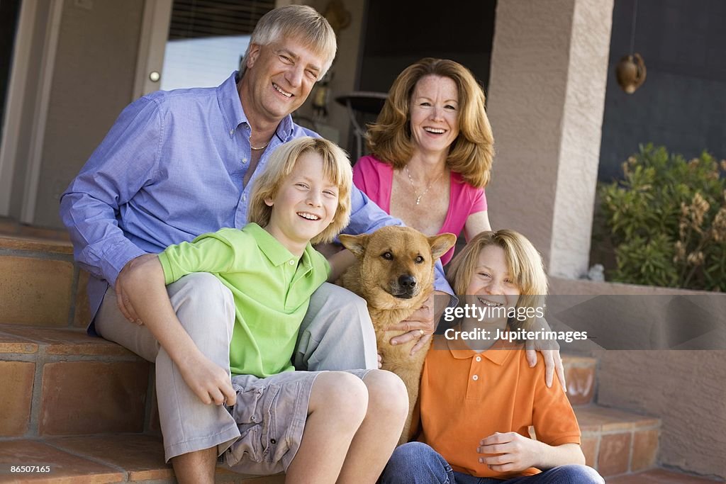Family with dog on front porch, Arizona