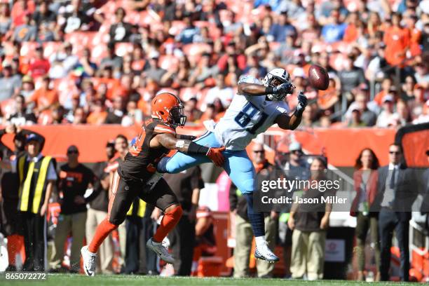 Jonnu Smith of the Tennessee Titans dives to catch a pass defended by Christian Kirksey of the Cleveland Browns in the first quarter at FirstEnergy...