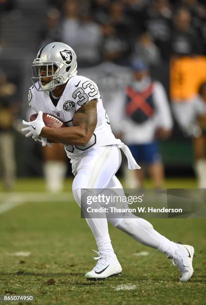 DeAndre Washington of the Oakland Raiders carries the ball against the Kansas City Chiefs during their NFL football game at Oakland-Alameda County...