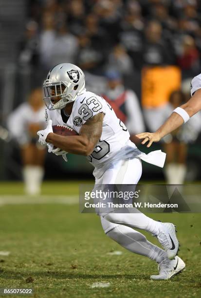 DeAndre Washington of the Oakland Raiders carries the ball against the Kansas City Chiefs during their NFL football game at Oakland-Alameda County...