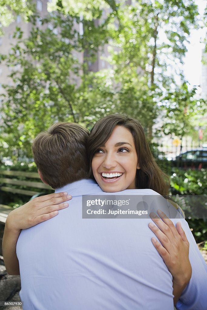 Couple embracing in park, New York City