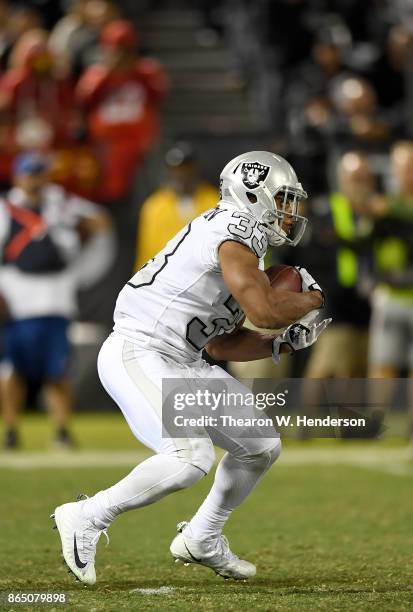 DeAndre Washington of the Oakland Raiders carries the ball against the Kansas City Chiefs during their NFL football game at Oakland-Alameda County...