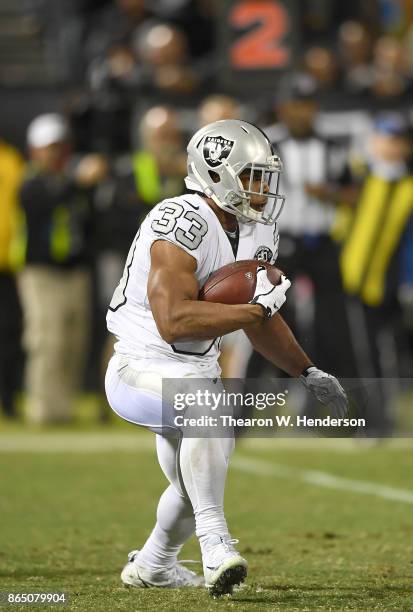 DeAndre Washington of the Oakland Raiders carries the ball against the Kansas City Chiefs during their NFL football game at Oakland-Alameda County...