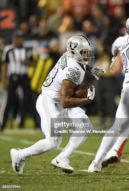 DeAndre Washington of the Oakland Raiders carries the ball against the Kansas City Chiefs during their NFL football game at Oakland-Alameda County...