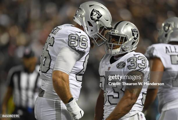 DeAndre Washington of the Oakland Raiders is congratulated by Lee Smith after Washington scored a touchdown against the Kansas City Chiefs during...