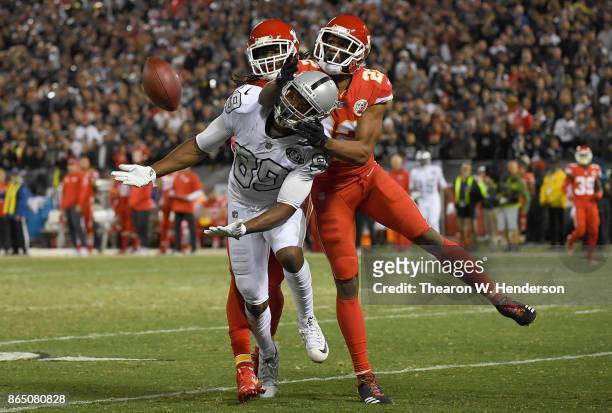 Marcus Peters of the Kansas City Chiefs is called for a pass interference penalty against Amari Cooper of the Oakland Raiders during their NFL...
