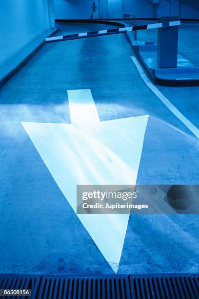 arrow on pavement - boom barrier stock pictures, royalty-free photos & images