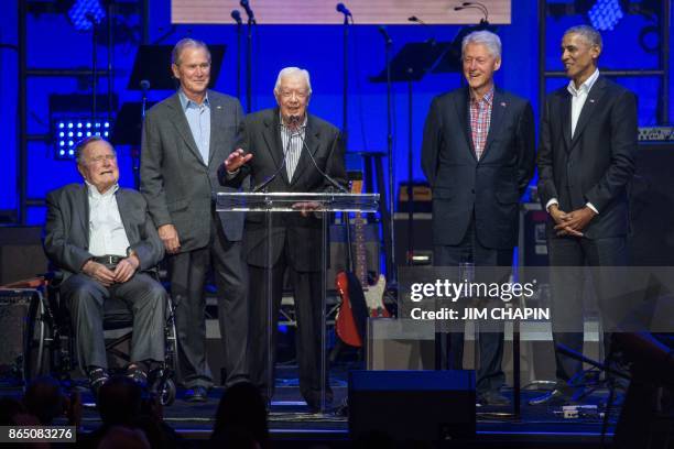 Former US President Jimmy Carter speaks along side former US Presidents George H. W. Bush, George W. Bush, Bill Clinton and Barack Obama as they...