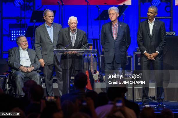 Former US President Jimmy Carter speaks along side former US Presidents George H. W. Bush, George W. Bush, Bill Clinton and Barack Obama as they...