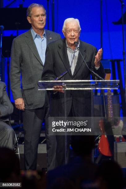 Former US President Jimmy Carter speaks along side former US President George W. Bush, as they attend the Hurricane Relief concert in College...
