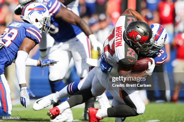 Doug Martin of the Tampa Bay Buccaneers is tackled by Jerry Hughes of the Buffalo Bills during an NFL game on October 22, 2017 at New Era Field in...