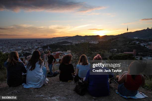 People watch the sunset over the city on October 22, 2017 in Barcelona, Spain. The Spanish government is to take steps to suspend Catalonia's...