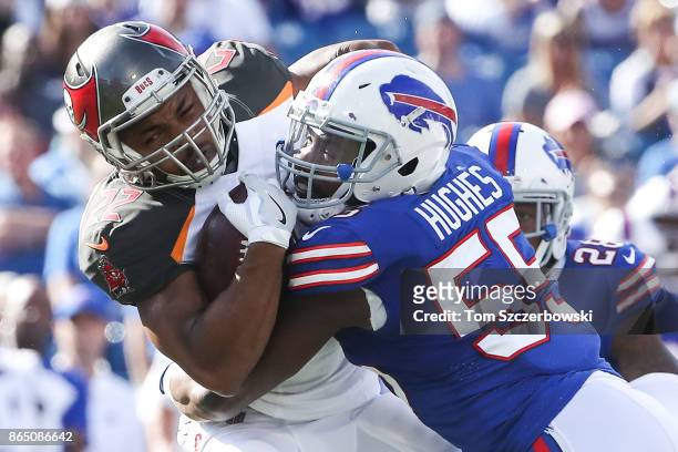 Doug Martin of the Tampa Bay Buccaneers is tackled by Jerry Hughes of the Buffalo Bills during an NFL game on October 22, 2017 at New Era Field in...