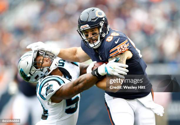 Zach Miller of the Chicago Bears carries the football against Shaq Thompson of the Carolina Panthers in the first quarter at Soldier Field on October...